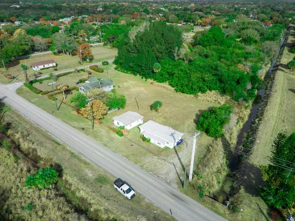 an aerial view of a residential houses with outdoor space
