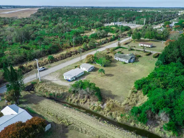 an aerial view of a house with a yard