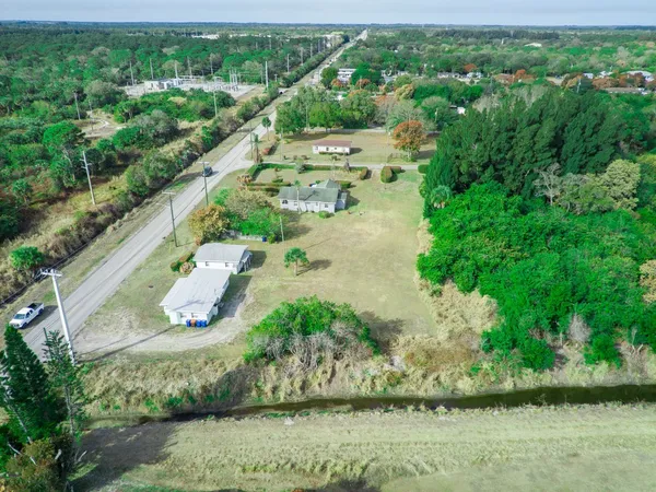 an aerial view of a house with a yard and lake view