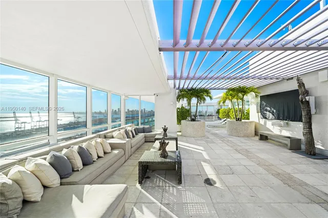 a living room with furniture and large windows