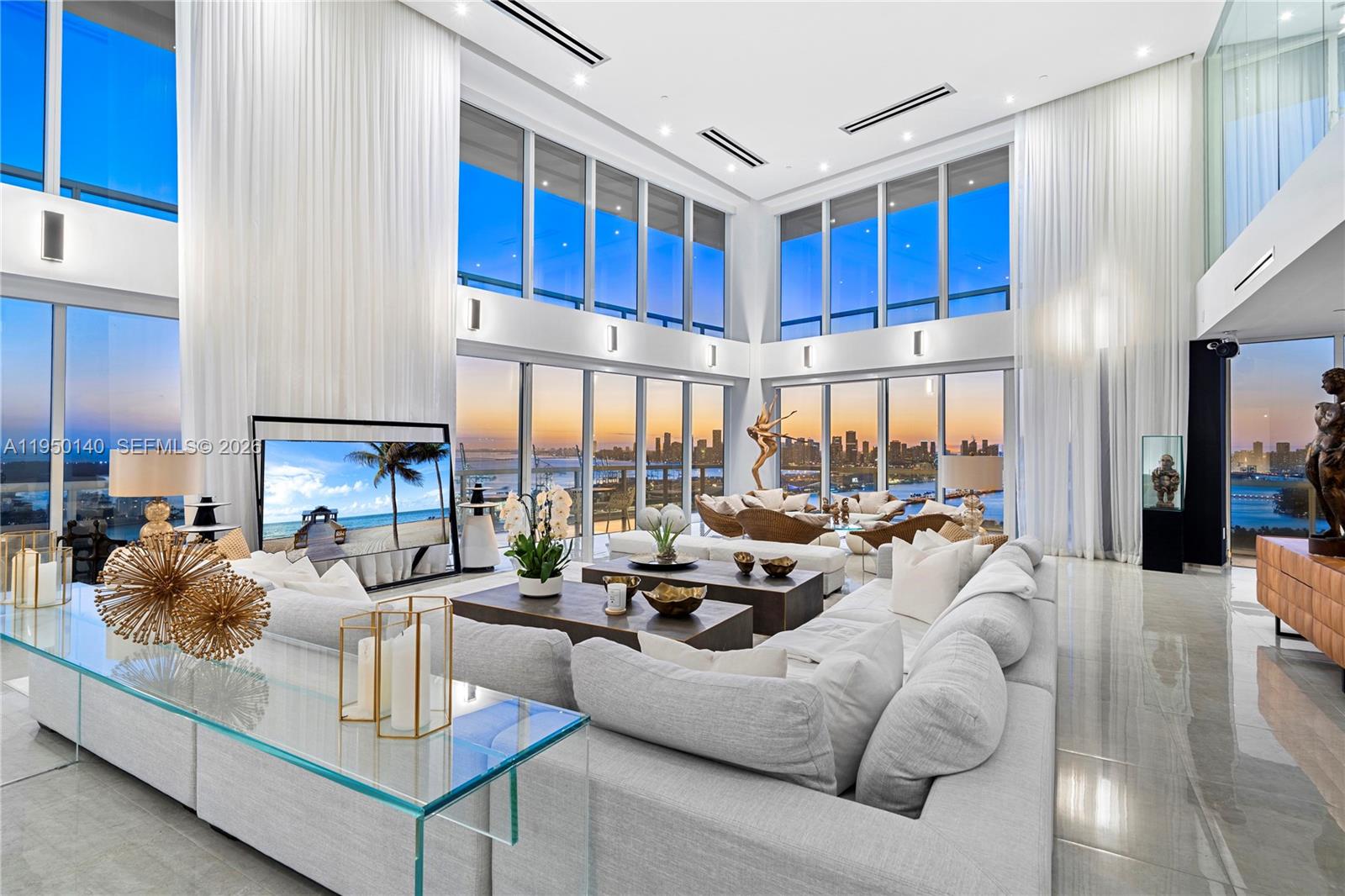 450 Alton Road, Unit PH1 Miami Beach, FL 33139 - Photo 2 of 98 a living room with furniture fireplace and a large window