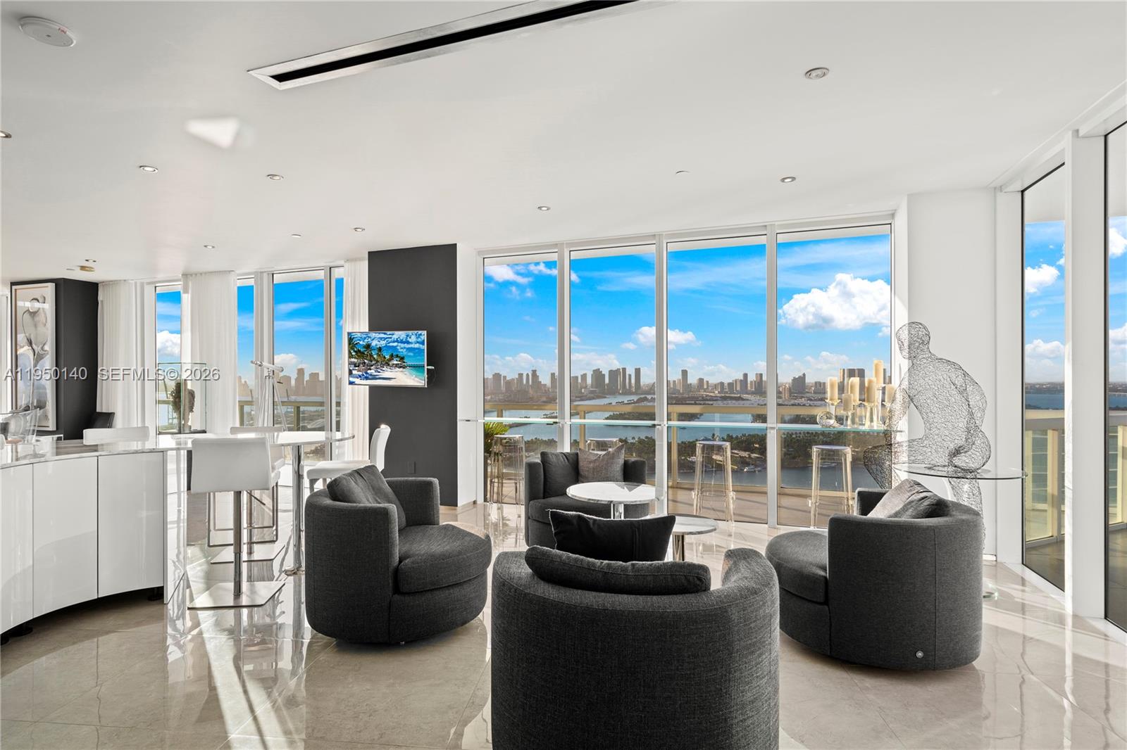 450 Alton Road, Unit PH1 Miami Beach, FL 33139 - Photo 38 of 98 a living room with furniture large windows and a kitchen view