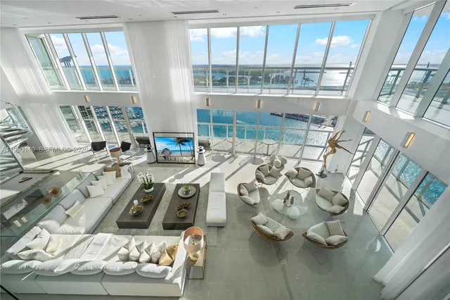 a view of a patio with table and chairs potted plants and palm trees
