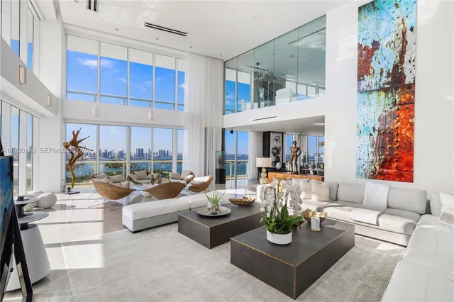 a view of a patio with couches table and chairs and potted plants