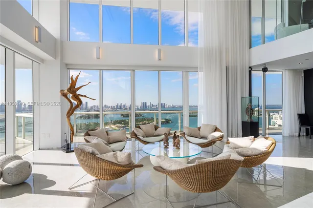 a living room with fireplace furniture and floor to ceiling window