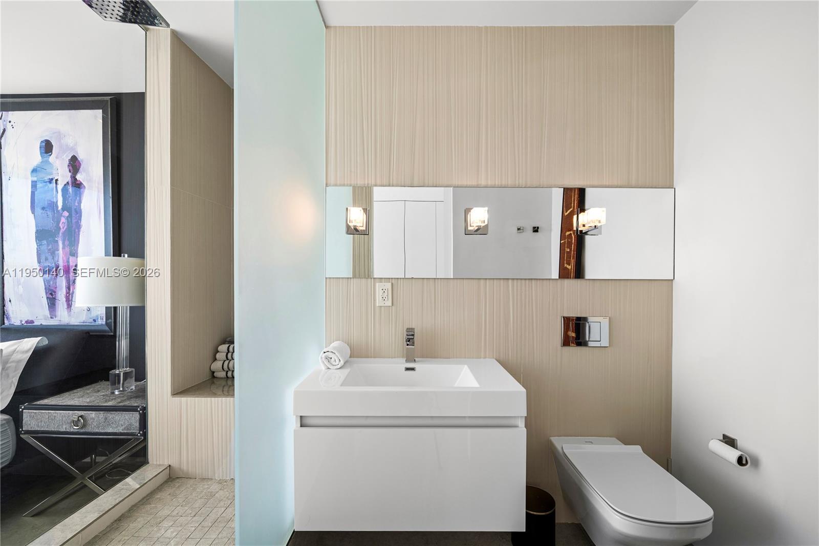 450 Alton Road, Unit PH1 Miami Beach, FL 33139 - Photo 65 of 98 a bathroom with a toilet sink and mirror