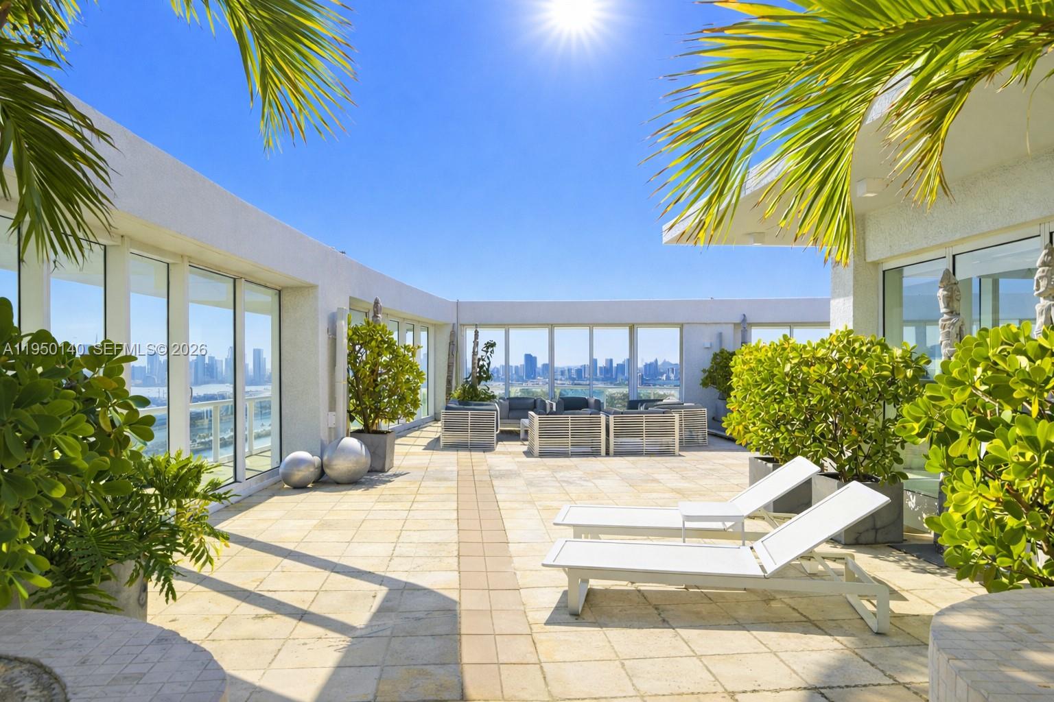 450 Alton Road, Unit PH1 Miami Beach, FL 33139 - Photo 8 of 98 a view of a patio with swimming pool table and chairs