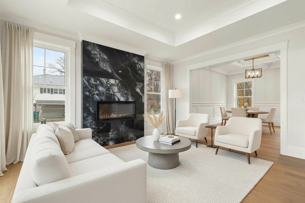 44 Buffington Street Attleboro, MA 02703 - Photo 11 of 41 a living room with furniture a fireplace and a large window
