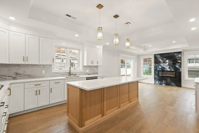 a kitchen with a sink cabinets and wooden floor