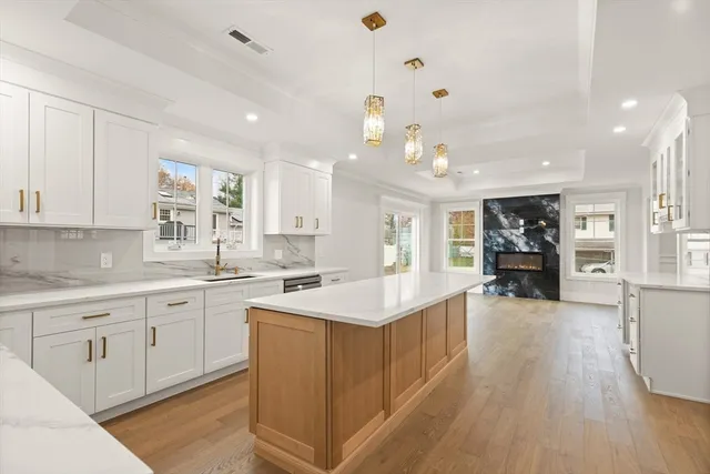 a large kitchen with kitchen island a sink counter space appliances and a center island