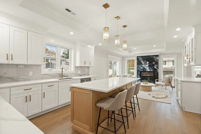 a large kitchen with kitchen island a island a sink and a stove in it