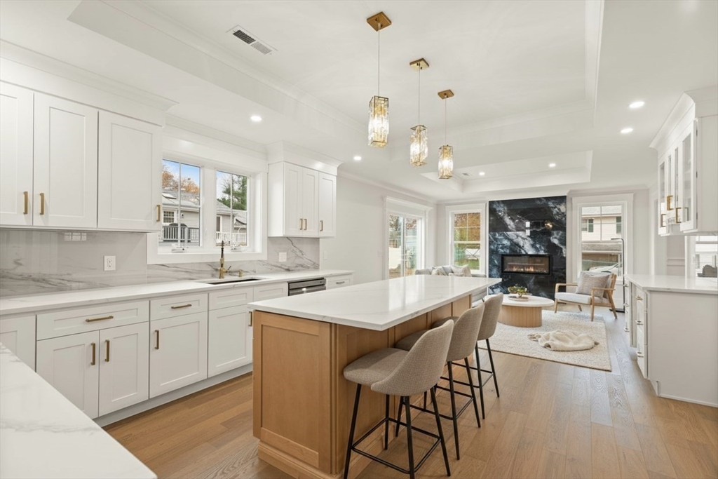 44 Buffington Street Attleboro, MA 02703 - Photo 19 of 41 a large kitchen with kitchen island a island a sink and a stove in it