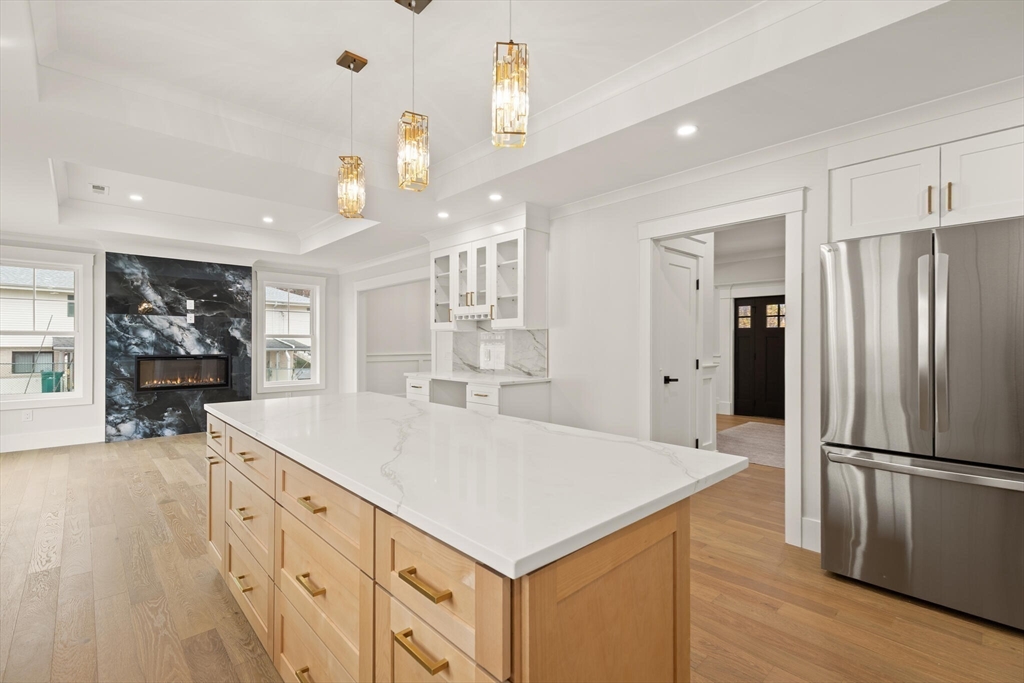 44 Buffington Street Attleboro, MA 02703 - Photo 20 of 41 a kitchen with granite countertop a refrigerator a sink dishwasher and a stove with wooden floor