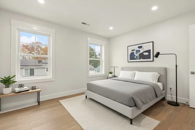 a bedroom with a large bed and a window