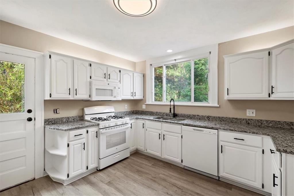 373 Goldsmith Road Pittsburgh, PA 15237 - Photo 22 of 40 a kitchen with granite countertop white cabinets white appliances a sink and a window
