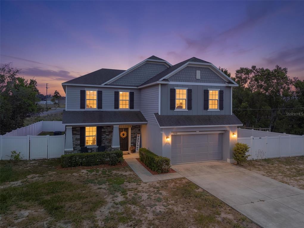 7242 Landmark Drive Spring Hill, FL 34606 - Photo 1 of 45 a front view of a house with a yard and garage