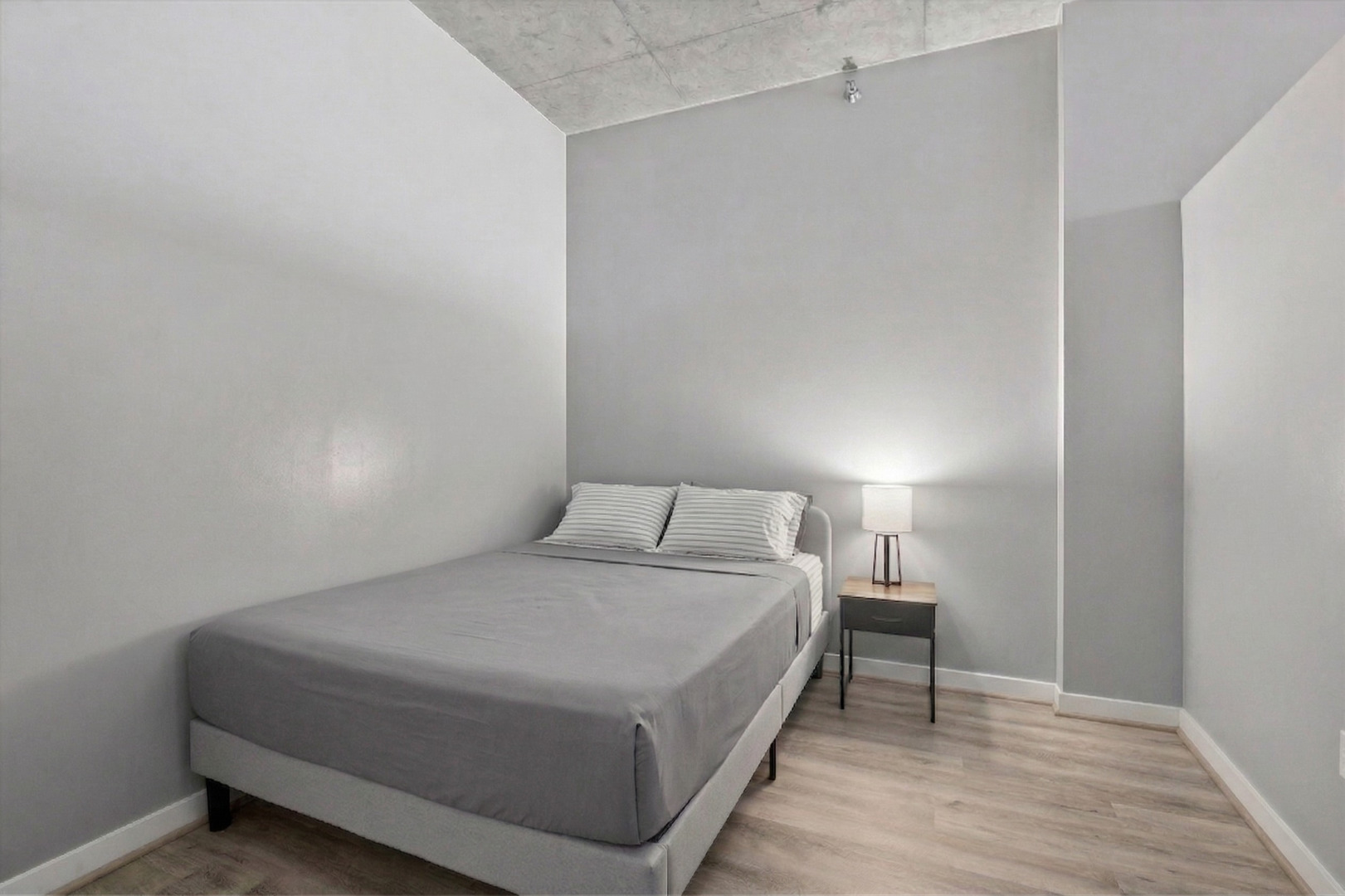235 West Van Buren Street, Unit 2513 Chicago, IL 60607 - Photo 11 of 18 a bedroom with a bed and a table