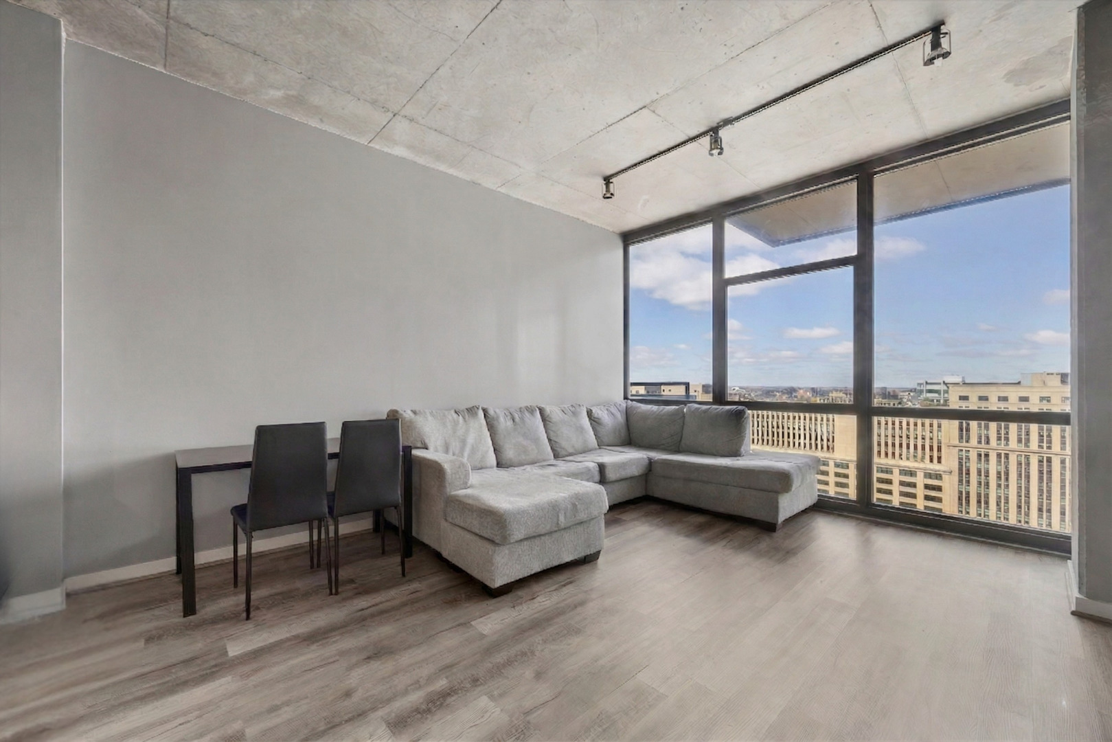 235 West Van Buren Street, Unit 2513 Chicago, IL 60607 - Photo 3 of 18 a living room with furniture and a floor to ceiling window