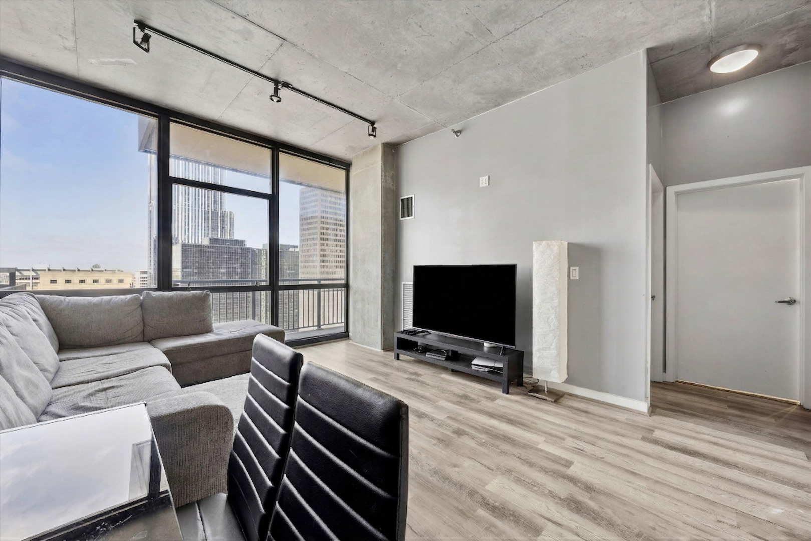 235 West Van Buren Street, Unit 2513 Chicago, IL 60607 - Photo 5 of 18 a living room with furniture and a flat screen tv