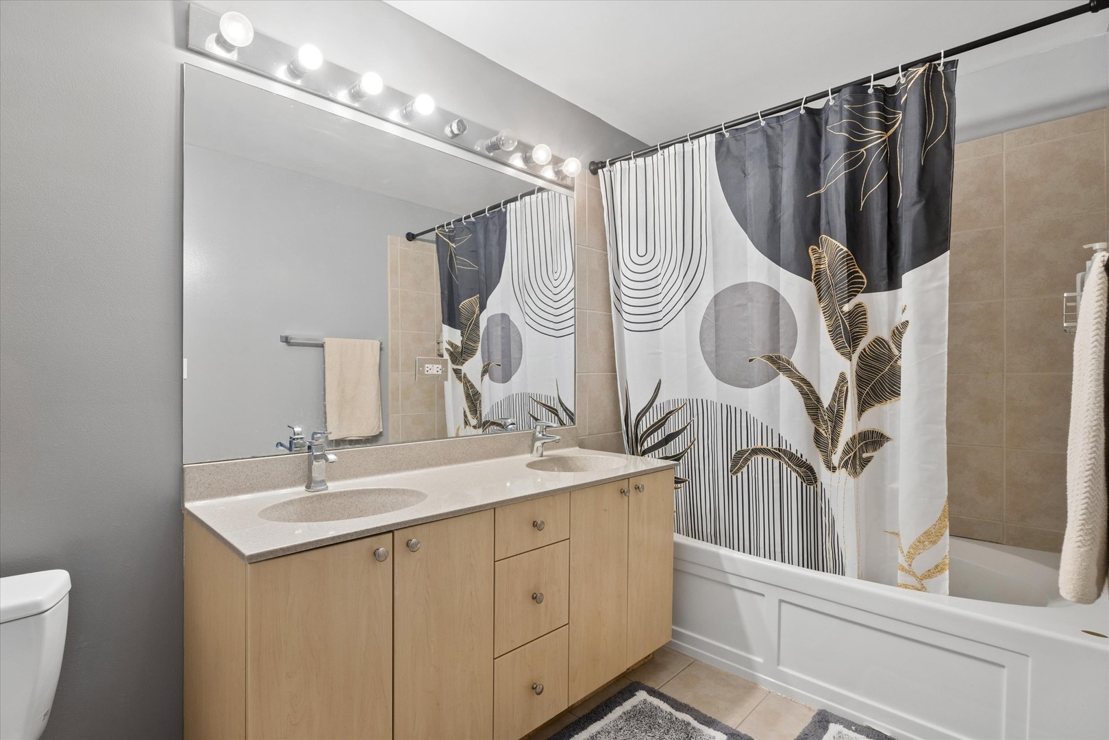 235 West Van Buren Street, Unit 2513 Chicago, IL 60607 - Photo 10 of 18 a bathroom with a sink a mirror and a shower curtain