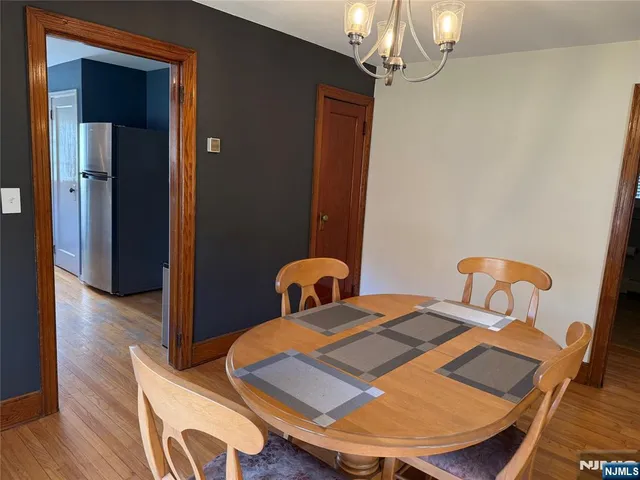 a bedroom with bed and wooden floor