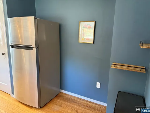 a view of empty room with closet and wooden floor