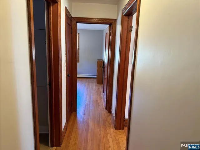 a view of a hallway with wooden floor