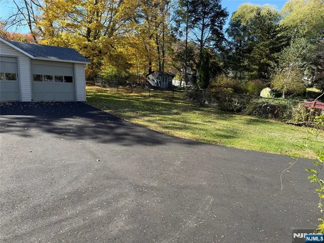 a view of yard with swimming pool and trees