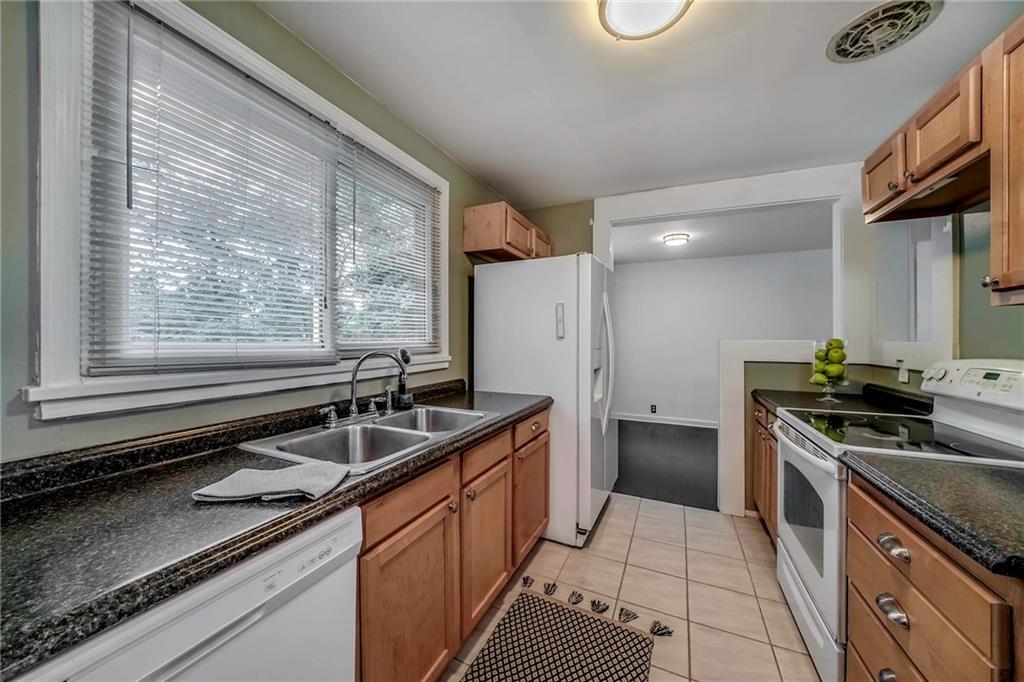 1073 Crest Drive Crescent, PA 15046 - Photo 11 of 33 a kitchen with granite countertop a sink stove and refrigerator