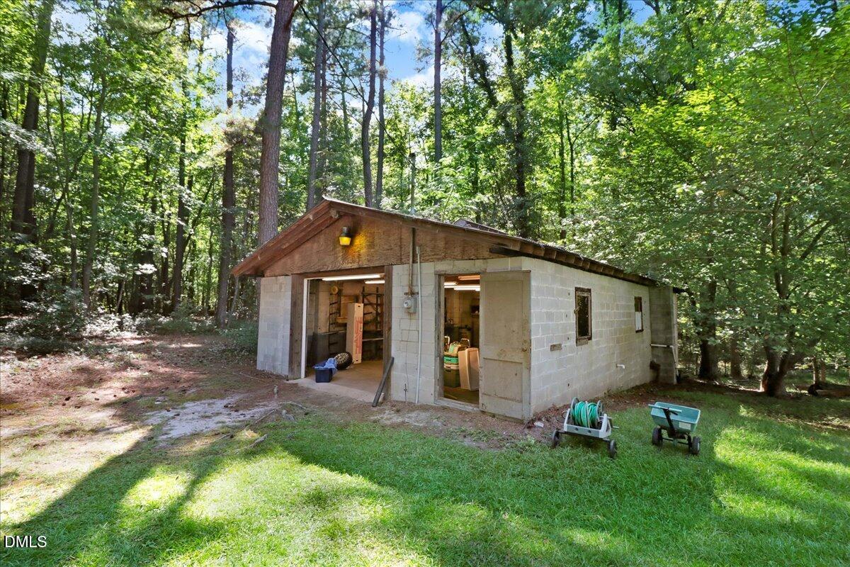15653 Buffalo Road Clayton, NC 27527 - Photo 6 of 6 a view of a backyard with a large tree