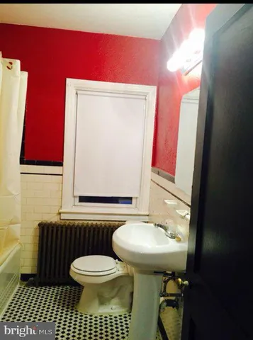 a bathroom with a sink a toilet and mirror