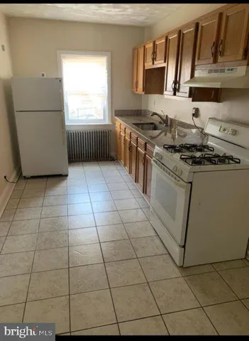a kitchen with stainless steel appliances granite countertop a stove a sink and a granite counter tops