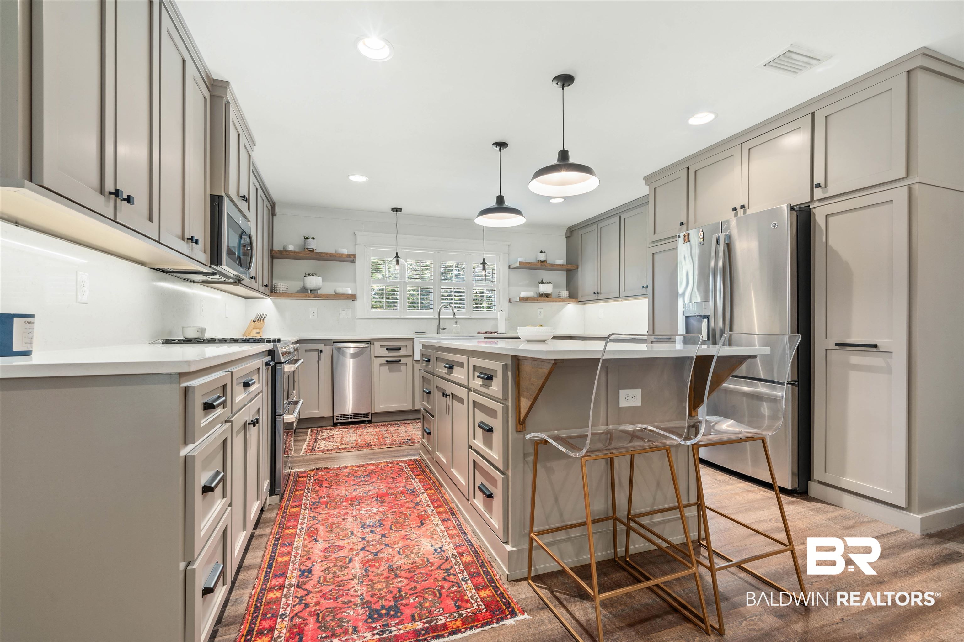 3808 Claridge Road North Mobile, AL 36608 - Photo 9 of 43 Kitchen featuring hanging light fixtures, a center island, a kitchen bar, light hardwood / wood-style floors, and appliances with stainless steel finishes