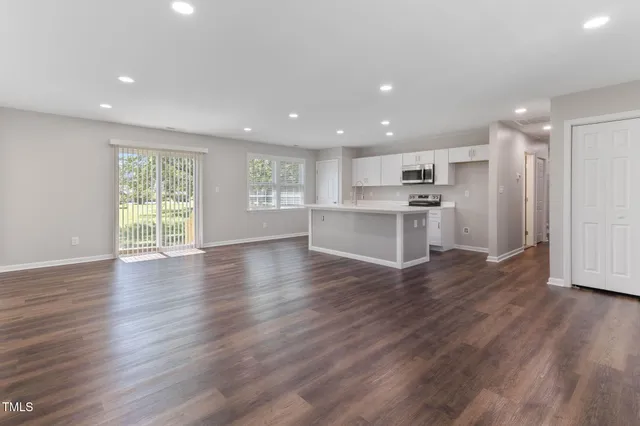 a view of kitchen with wooden floor and window