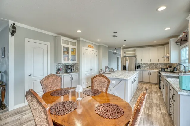 a kitchen with kitchen island a sink appliances and wooden floor