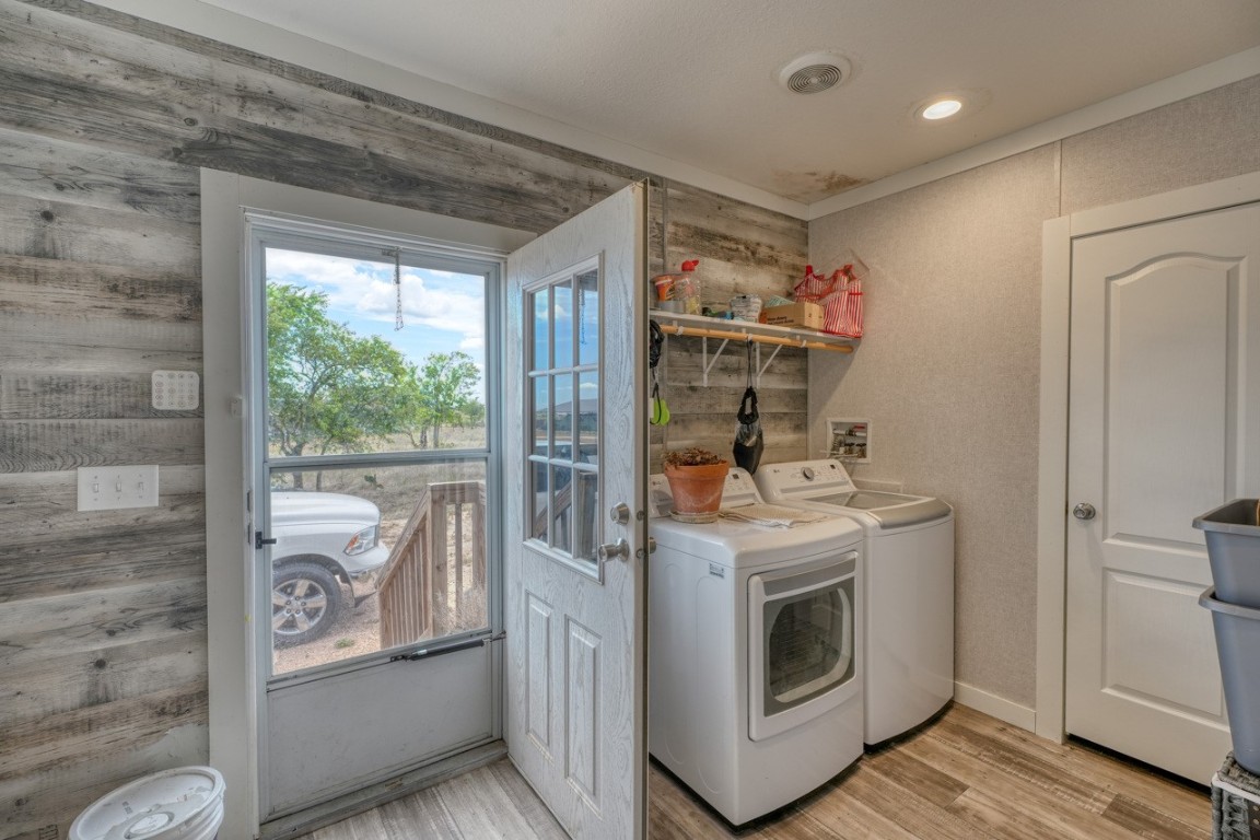 101 Samuel Drive Bertram, TX 78605 - Photo 16 of 30 a view of a hallway with washer and dryer