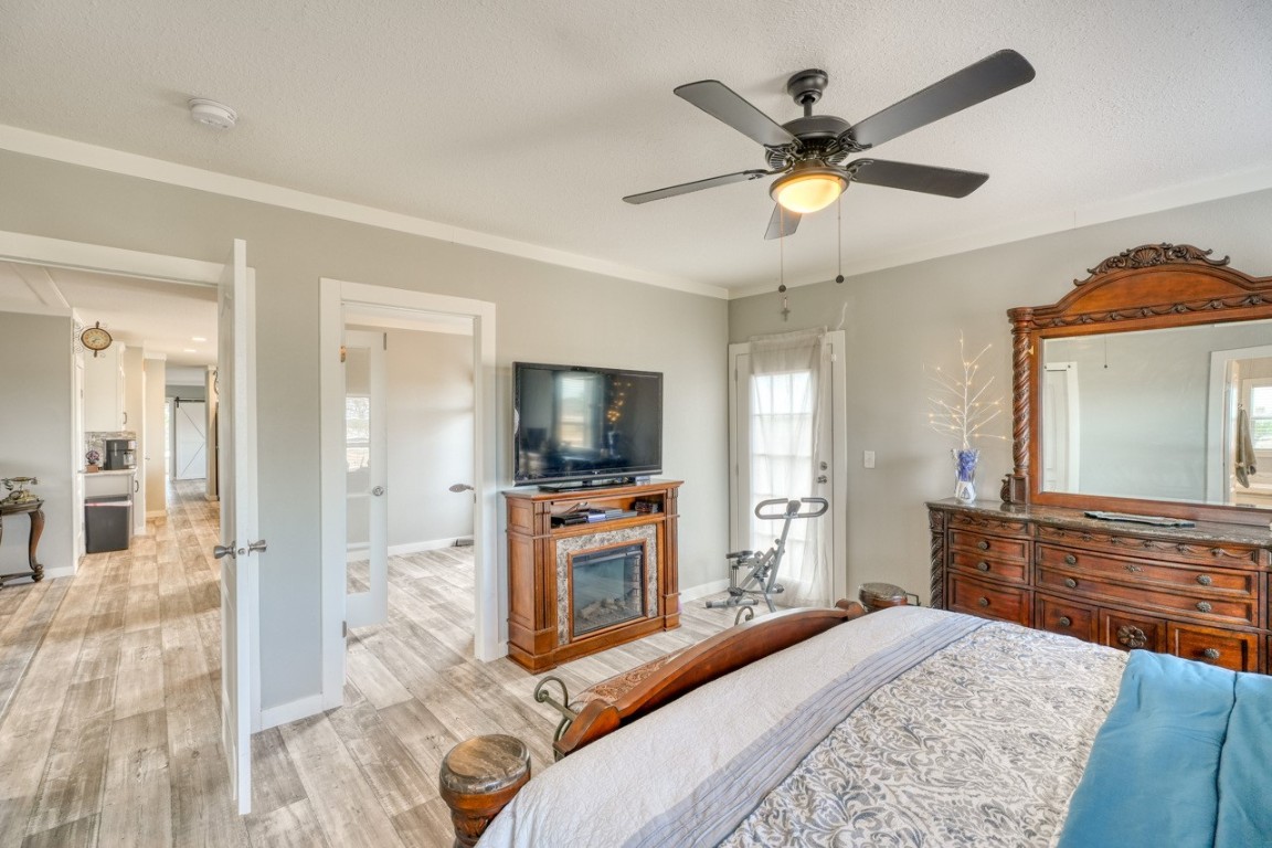 101 Samuel Drive Bertram, TX 78605 - Photo 20 of 30 a bedroom with a bed a flat screen tv and a large window
