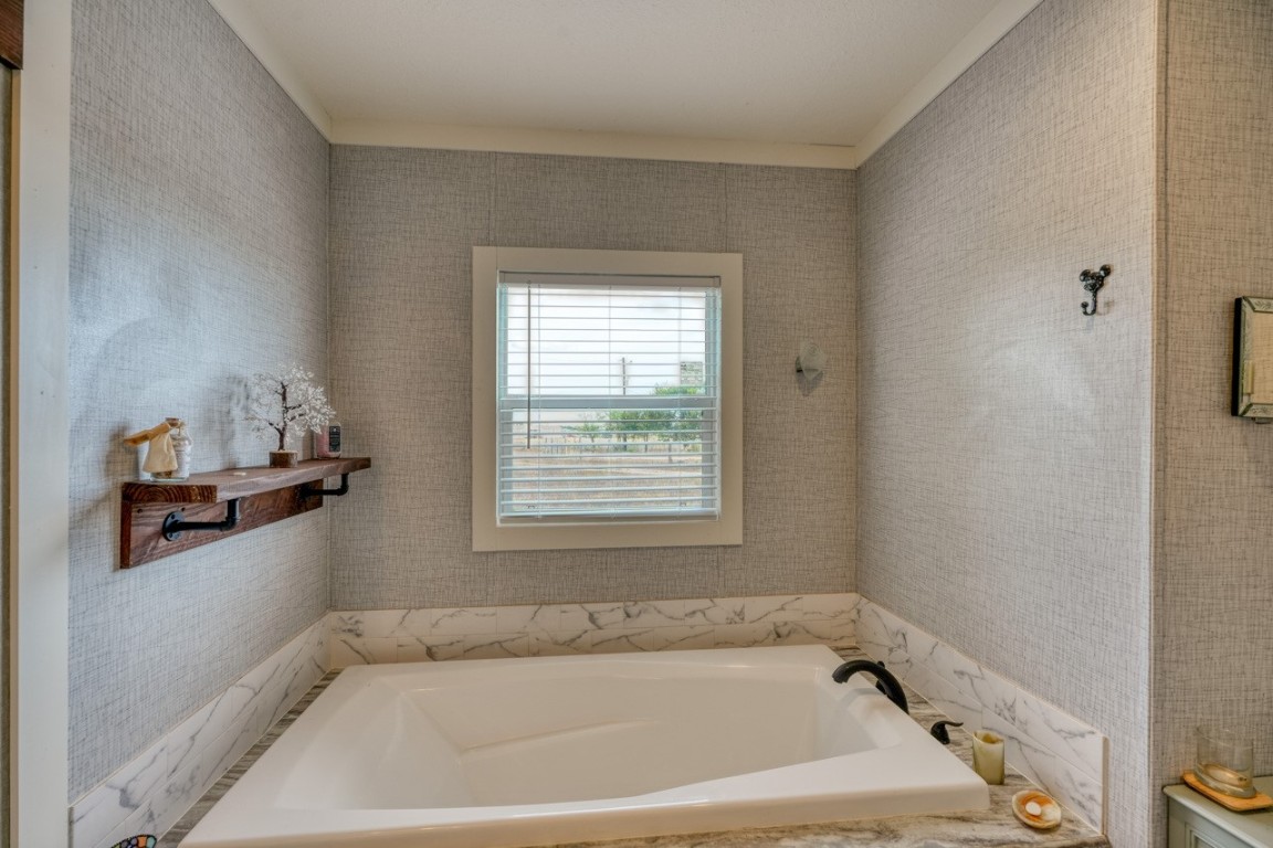 101 Samuel Drive Bertram, TX 78605 - Photo 22 of 30 a white bath tub sitting in a bathroom next to a window