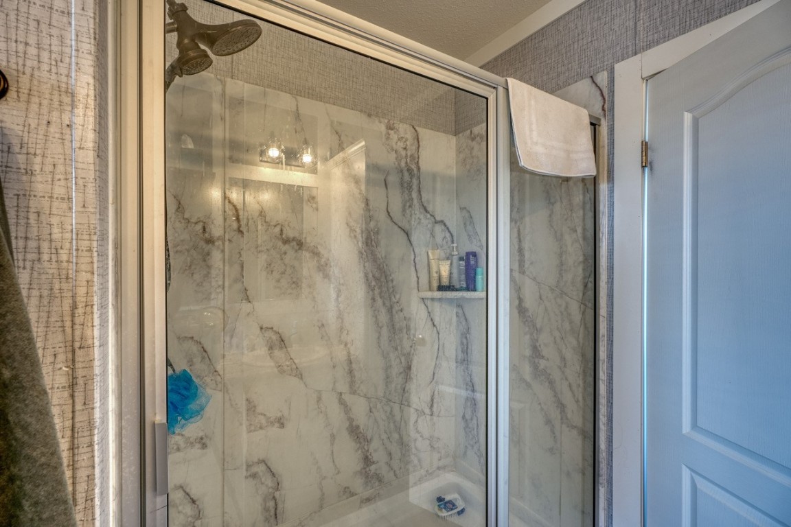101 Samuel Drive Bertram, TX 78605 - Photo 24 of 30 a bathroom with a glass shower door