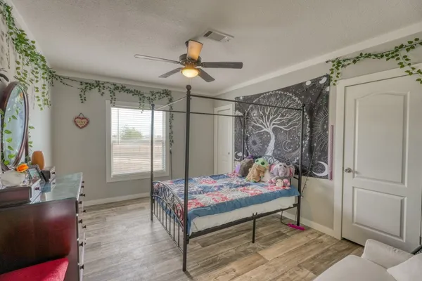 a bedroom with a bed a table and chair