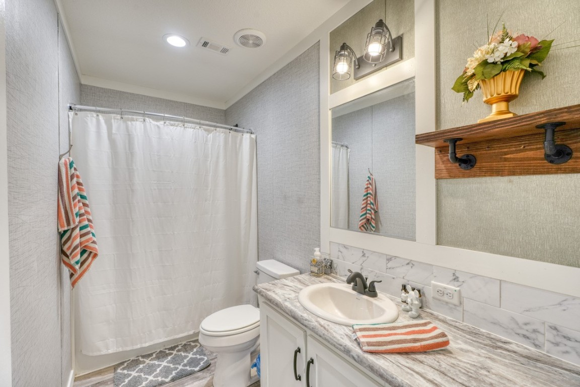 101 Samuel Drive Bertram, TX 78605 - Photo 29 of 30 a bathroom with a granite countertop sink and a mirror