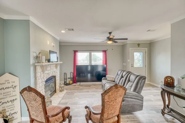 a living room with stainless steel appliances granite countertop furniture a couch and a view of kitchen
