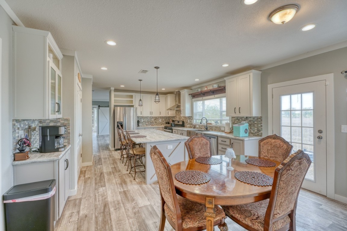 101 Samuel Drive Bertram, TX 78605 - Photo 10 of 30 a view of a dining room with furniture window and wooden floor
