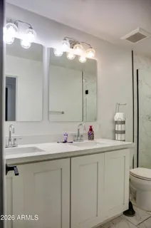 a bathroom with a sink vanity and a mirror