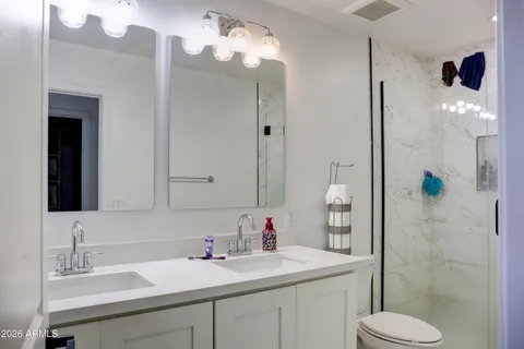 a bathroom with a sink toilet and shower