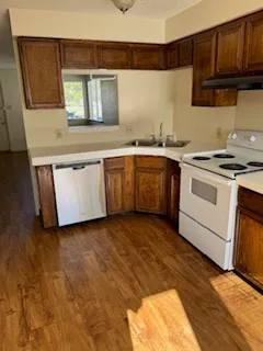 a kitchen with granite countertop a sink and a stove