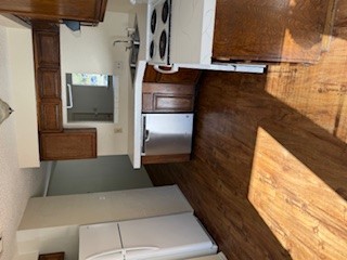307 West William Cannon Drive, Unit A Austin, TX 78745 - Photo 6 of 14 a kitchen with stainless steel appliances granite countertop a sink stove and wooden floor