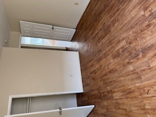 307 West William Cannon Drive, Unit A Austin, TX 78745 - Photo 7 of 14 a view of an empty room with wooden floor and a window