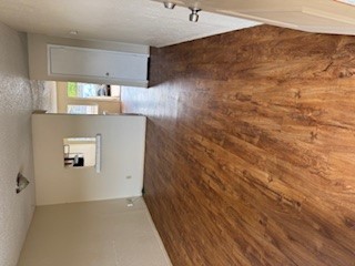 307 West William Cannon Drive, Unit A Austin, TX 78745 - Photo 8 of 14 an empty room with wooden floor and windows