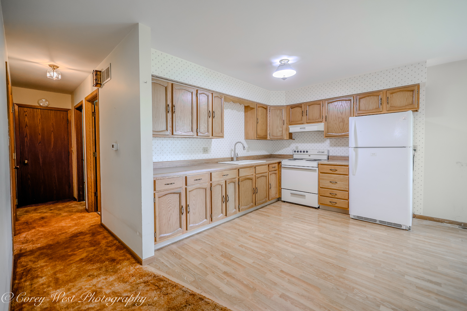 335 South Hadsall Street Genoa, IL 60135 - Photo 8 of 23 a kitchen with white cabinets and white appliances